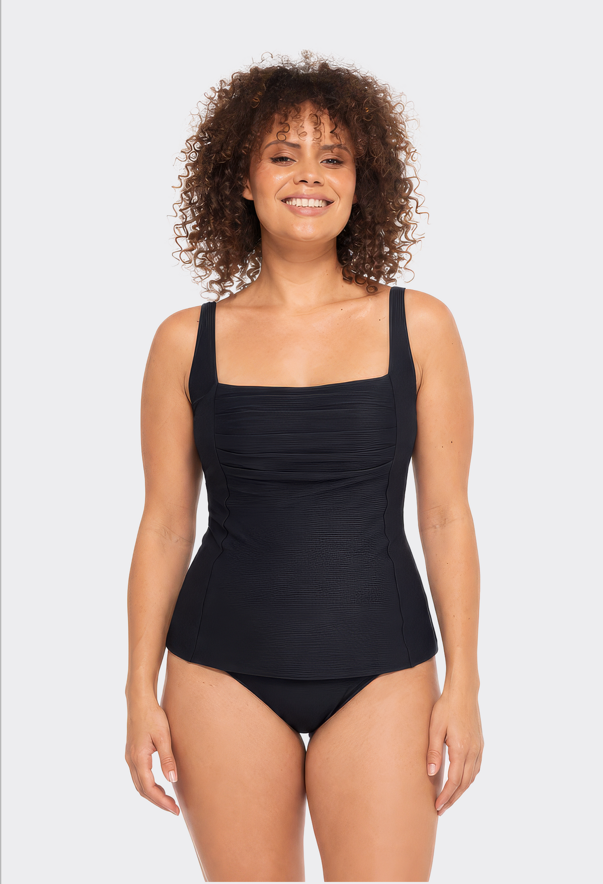 Woman wearing the black ribbed texture tankini set with a square neckline and pleated bust